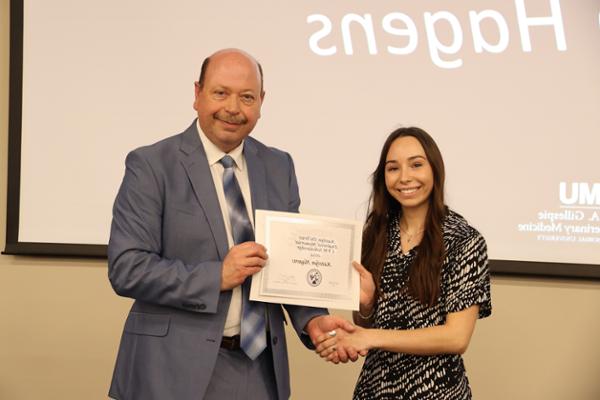 Hagen receiving scholarship certificate